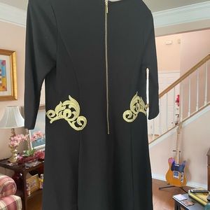 Black dress with gold appliqué and gold zipper